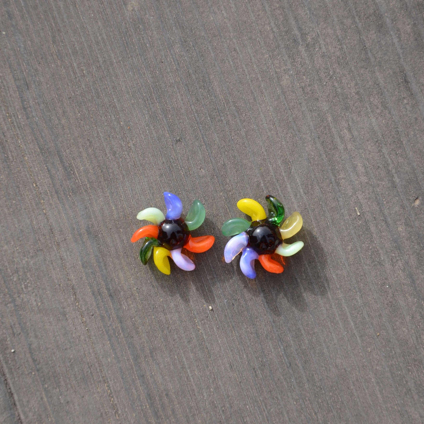 Calibear 15mm terp spinners in purple and green glass, featuring an 8-arm pinwheel design for Dr. Dabber Switch 2 and 25mm quartz bangers.
