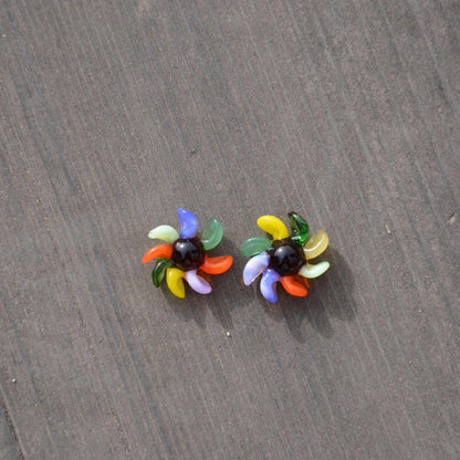 Calibear 15mm terp spinners in purple and green glass, featuring an 8-arm pinwheel design for Dr. Dabber Switch 2 and 25mm quartz bangers.