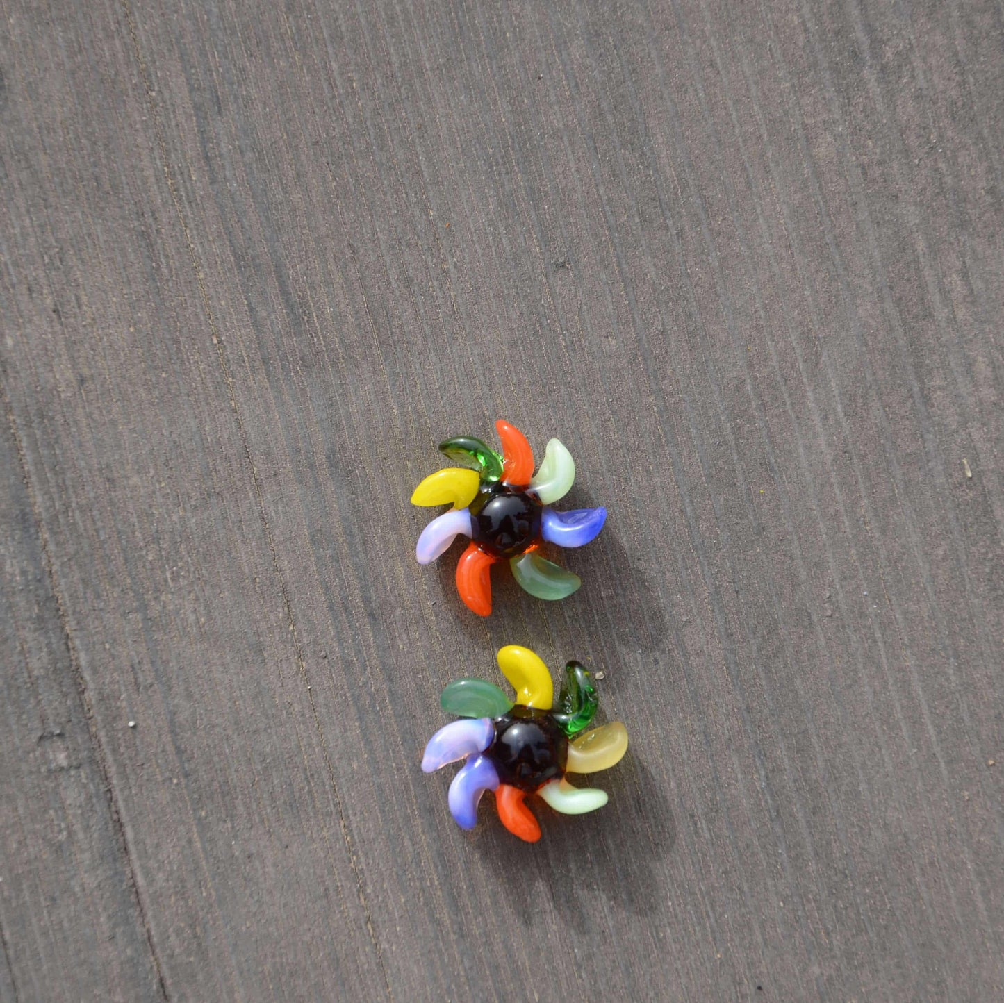 Calibear 15mm terp spinners in purple and green glass, featuring an 8-arm pinwheel design for Dr. Dabber Switch 2 and 25mm quartz bangers.
