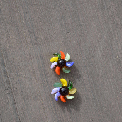 Calibear 15mm terp spinners in purple and green glass, featuring an 8-arm pinwheel design for Dr. Dabber Switch 2 and 25mm quartz bangers.